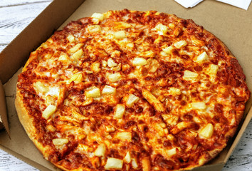 Pizza in box on wooden table, closeup,closeup
