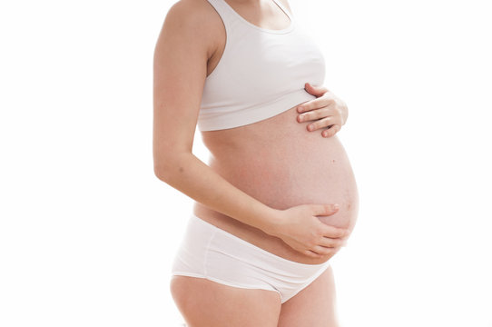Pregnant woman wearing white lingerie