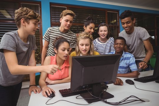 Smiling Students Studying Together In Computer Classroom