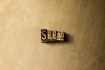 SEEK - close-up of grungy vintage typeset word on metal backdrop. Royalty free stock illustration.  Can be used for online banner ads and direct mail.