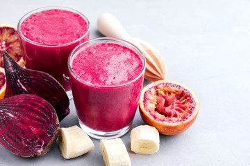 Healthy beetroot, orange and banana smoothie Wooden background Copy space Healthy food