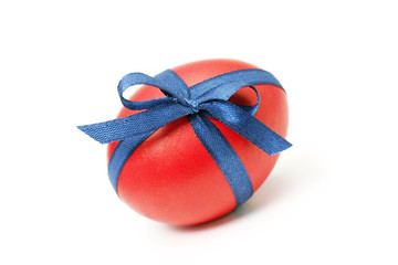 Easter egg tied in a bow isolated on white