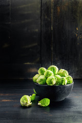 Ingredients Brussels Sprout on black wooden table. Selective focus