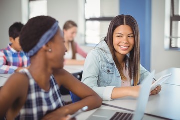 Students interacting with each other in classroom