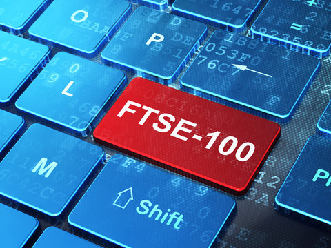Stock market indexes concept: FTSE-100 on computer keyboard background
