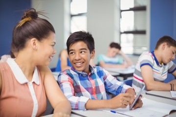 Student using mobile phone in classroom
