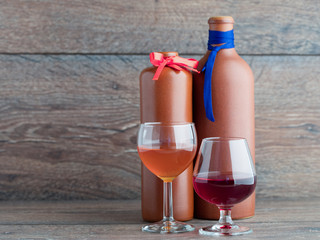 Two balsam bottle and two filled glasses on the wooden background