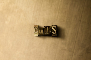 CUTS - close-up of grungy vintage typeset word on metal backdrop. Royalty free stock illustration.  Can be used for online banner ads and direct mail.