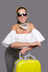 Glamour woman with yellow suitcase, travel concept