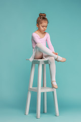 The little balerina dancer on blue background © master1305