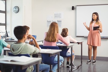 Schoolgirl giving presentation in classroom