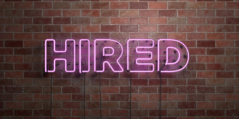 HIRED - fluorescent Neon tube Sign on brickwork - Front view - 3D rendered royalty free stock picture. Can be used for online banner ads and direct mailers..