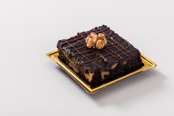 Chocolate cake with walnuts on a white background