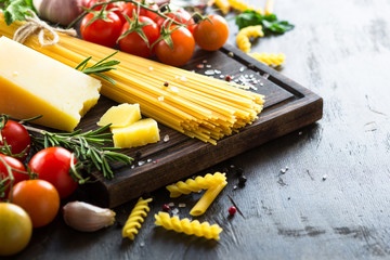 Raw pasta spaghetti and cooking ingredients. Italian food background