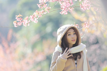 beautiful young woman with blooming cherry blossoms sakura flowers