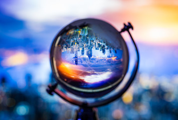 Crystal globe reflection cityscape inside with blur background