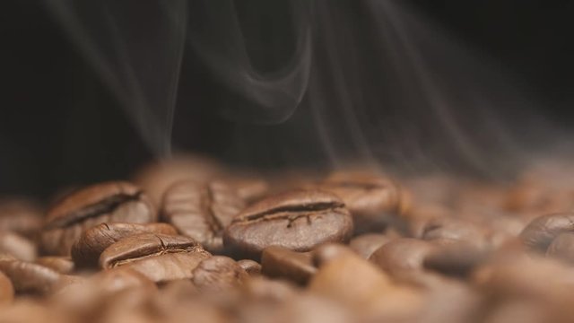 MACRO: Smoke over a roasted coffee beans (slow motion)