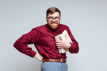 Smiling Male nerd with books