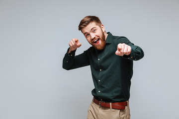 Happy funny Bearded man in shirt pointing at camera