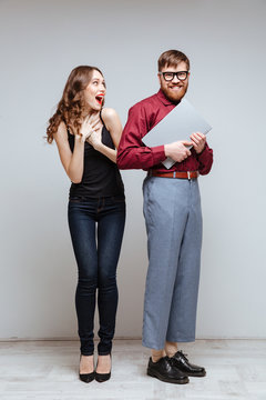 Vertical image of Happy Surprised woman with Male nerd