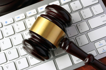 Gavel and keyboard. Internet fraud concept.