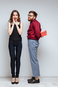 Vertical image of Male nerd presents the gift for Woman