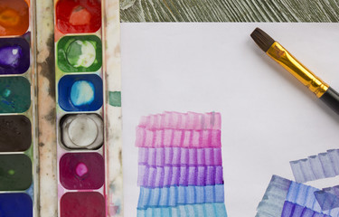 Used watercolor paints palette in a box, paper and acrylic watercolour brush. Glazing lesson for the beginner, artist, student, pupil. First coloristic step, colour gradient. Drawing lesson in college