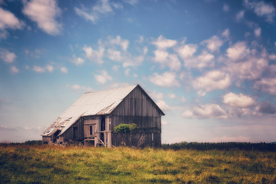 An Old Abandoned Barn in a Field