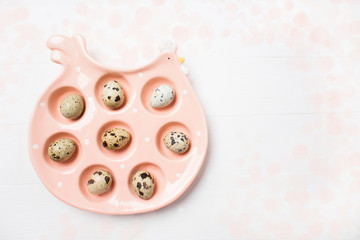 Fototapeta na wymiar Pink ceramic chiken with eggs on soft blurred background. Easter concept
