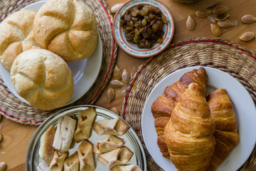 Croissant, buns and homemade cookies on wooden table background