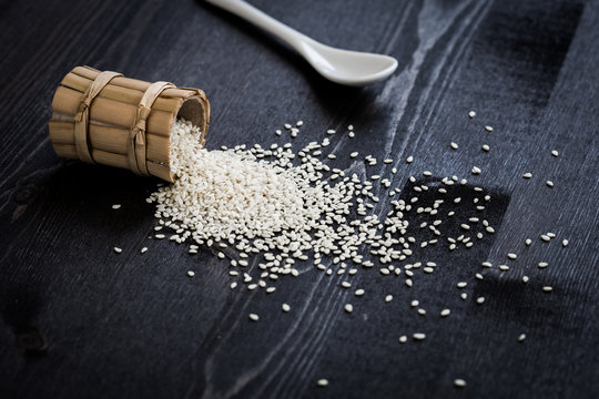 white sesame seeds on wooden table