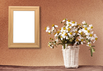 blank wooden frame mockup with basket of chamomile flowers