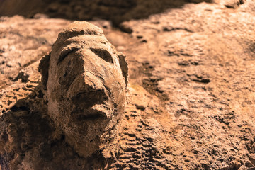 Old human face carving art in Chiang Dao Cave at Wat Tham Chiang Dao in Chiangmai Thailand.