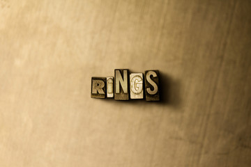 RINGS - close-up of grungy vintage typeset word on metal backdrop. Royalty free stock illustration.  Can be used for online banner ads and direct mail.