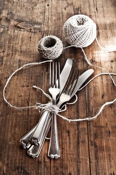 A bundle of knives and fork tied with kitchen twine