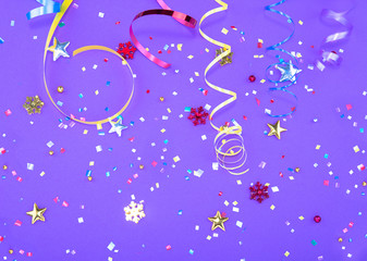 Red, yellow and green heart and circle confetti on a PURPLE background.