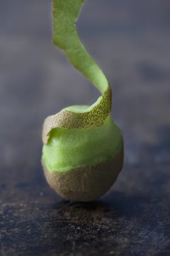 Partially peeled kiwi fruit