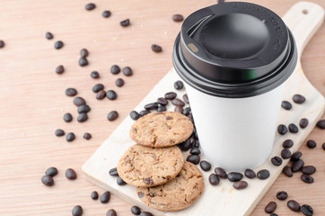 Coffee cup and coffee beans on wooden background