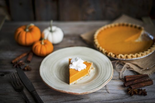 Pumpkin pie on rustic wooden surface