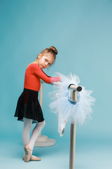 The little balerina dancer on blue background © master1305