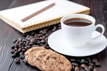 Coffee cup and coffee beans on wooden background