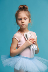 The little balerina dancer on blue background © master1305