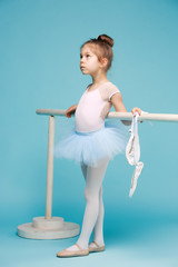 The little balerina dancer on blue background © master1305