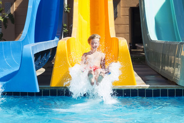 Boy has a good time in aquapark in the summer