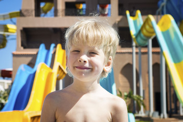 Portrait of the smiling boy against the background of aquapark