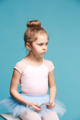 The little balerina dancer on blue background © master1305