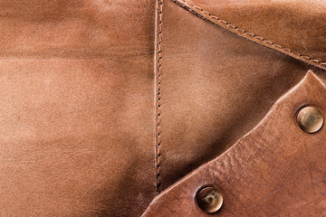 Closeup image of brown old leather texture patchwork with rivets as natural background. - obrazy, fototapety, plakaty