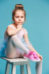 The little balerina dancer on blue background © master1305