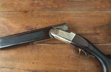 hunting gun on a wooden background