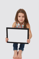 Fototapeta premium Cute girl holding a blank sign
